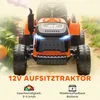 A close-up, low-angle shot of an orange electric toy tractor with smoke coming from the exhaust, set in an outdoor, grassy environment with pumpkins visible. Náhľad obrázku produktu