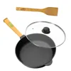 A cast iron pan with a wooden handle and a glass lid, along with a wooden spatula, are displayed against a white background. Produktbild-Vorschau