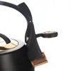 A close-up shot of the handle and lid of a black and gold kettle. Náhled obrázku produktu