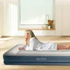 A woman lying on an inflatable mattress in a bright, modern room. Podgląd zdjęcia produktu