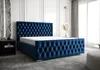 A luxurious blue tufted bed with a mattress is shown in a modern bedroom setting. Náhled obrázku produktu