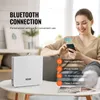 A woman is using a smartphone to control a white diffuser on a table, with text overlays highlighting features. Náhled obrázku produktu