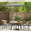 An outdoor patio scene with a table, chairs, and an umbrella. Podgląd zdjęcia produktu