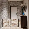 An entryway with a door, a dresser, and a wall covered in brick-patterned wallpaper. A rug with a wood block pattern is in the foreground. Produktbild-Vorschau