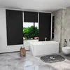 A modern bathroom with a bathtub, toilet, and a window with blinds. Produktbild-Vorschau
