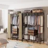 An open wardrobe with clothes hanging and items stored on shelves and in drawers. Produktbild-Vorschau