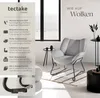 A light gray armchair with a bouclé fabric cover is shown in a modern living room setting with minimalist side tables and decor. Náhled obrázku produktu