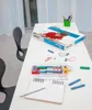 A table with a science experiment kit, a notebook, and pencils. Anteprima dell’immagine prodotto