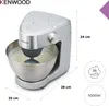 A silver Kenwood kitchen machine is shown in a studio setting with dimensions and feature icons displayed. Produktbild-Vorschau
