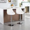 Two white bar stools are placed in front of a kitchen counter. Produktbild-Vorschau