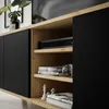 A close-up view of a modern TV cabinet with black doors and artisan oak shelves. Náhled obrázku produktu