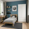 A bedroom with a bed, desk, chair, and wardrobe. Voir les images du produit