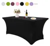 A black rectangular tablecloth is shown on a table, with a vase of flowers, a bottle of wine, and a plate on top. Produktbild-Vorschau