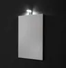 A rectangular mirror with a LED light mounted above it, set against a dark, textured wall. Anteprima dell’immagine prodotto