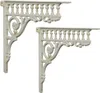 Two white cast iron shelf brackets are shown against a white background. Náhľad obrázku produktu