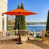 An orange patio umbrella is set up on a wooden deck overlooking a body of water. Produktbild-Vorschau