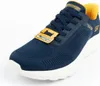 A close-up, angled view of a single navy blue Skechers Slip-Ins shoe with a yellow interior and white sole, set against a white background. A yellow tag is attached to the laces. Voir les images du produit