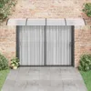 A vidaXL door canopy is installed above a sliding glass door on a brick wall. Náhľad obrázku produktu