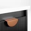 A close-up shot of a cabinet drawer with a copper handle. Náhled obrázku produktu
