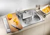 A stainless steel kitchen sink with a cutting board, knife, and pumpkin slices. Náhľad obrázku produktu