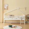 A white house-shaped bed with fairy lights, decorated with stuffed animals and a children's play mat with toys. Produktbild-Vorschau