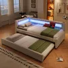 A modern bedroom with a daybed and a pull-out trundle bed, featuring LED lighting. Produktbild-Vorschau