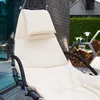 A close-up view of a cream-colored hanging lounge chair with a black frame, set on a wooden deck outdoors. Voir les images du produit