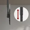 A side view of a black ceiling mount for a TV, with a close-up inset showing an adjustable pole with a red arrow indicating vertical movement. Anteprima dell’immagine prodotto
