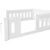 A white wooden bed frame with safety rails, shown from a low angle against a white background. Náhled obrázku produktu