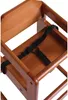 Close-up view of a wooden high chair with a black safety harness. Podgląd zdjęcia produktu
