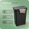 A dark grey woven laundry basket with a lid, featuring informational callouts on the left side. Produktbild-Vorschau
