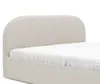 A close-up view of the headboard and frame of a beige upholstered bed with a white sheet. Voir les images du produit