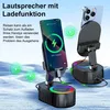Two black speaker stands with phones charging on them, set against a light blue and white background. Produktbild-Vorschau