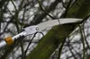 A close-up of a telescopic pruning saw cutting a tree branch. Produktbild-Vorschau