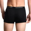 A person wearing black Emporio Armani boxer shorts. Produktbild-Vorschau