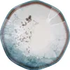 A top-down view of a single, irregularly shaped plate with a marbled design. Voir les images du produit