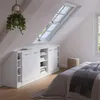 A bedroom corner with a built-in wardrobe under a slanted ceiling and skylight. A bed with a blanket is in the foreground. Voir les images du produit