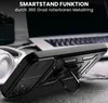 A black smartphone case with a kickstand is shown in a close-up shot, with a laptop and headphones in the background. Produktbild-Vorschau