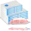 A stack of vacuum seal bags with one bag filled with pink and white bedding shown in the foreground, and another bag with bedding shown compressed at the bottom. Voir les images du produit