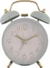A light blue analog alarm clock with gold accents is shown against a white background. Anteprima dell’immagine prodotto
