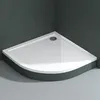 A white quarter-circle shower tray is shown in a bathroom corner with dark gray tiled walls and a light gray tiled floor. Produktbild-Vorschau