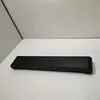 A black soundbar is placed on a white surface with a light gray wall in the background. Produktbild-Vorschau