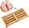 A close-up view of a wooden foot massager with a person's feet using it. Náhľad obrázku produktu