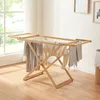 A wooden drying rack with clothes hanging on it, placed near a window in a room. Anteprima dell’immagine prodotto