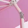 A close-up view of the mechanism and fabric of a pink umbrella. Náhľad obrázku produktu