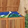 A garden box containing gardening tools like a watering can and a hose. Podgląd zdjęcia produktu