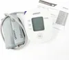 An Omron blood pressure monitor and its cuff are laid out on a white background, with an instruction manual nearby. Náhľad obrázku produktu