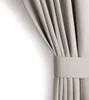 A close-up of a light beige curtain with pleats and a band. Produktbild-Vorschau