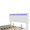 A close-up view of a white tufted headboard with blue LED lighting, part of a bed frame, against a white background. Náhled obrázku produktu