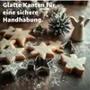 Christmas cookies and cookie cutters on a wooden surface, dusted with powdered sugar. Produktbild-Vorschau